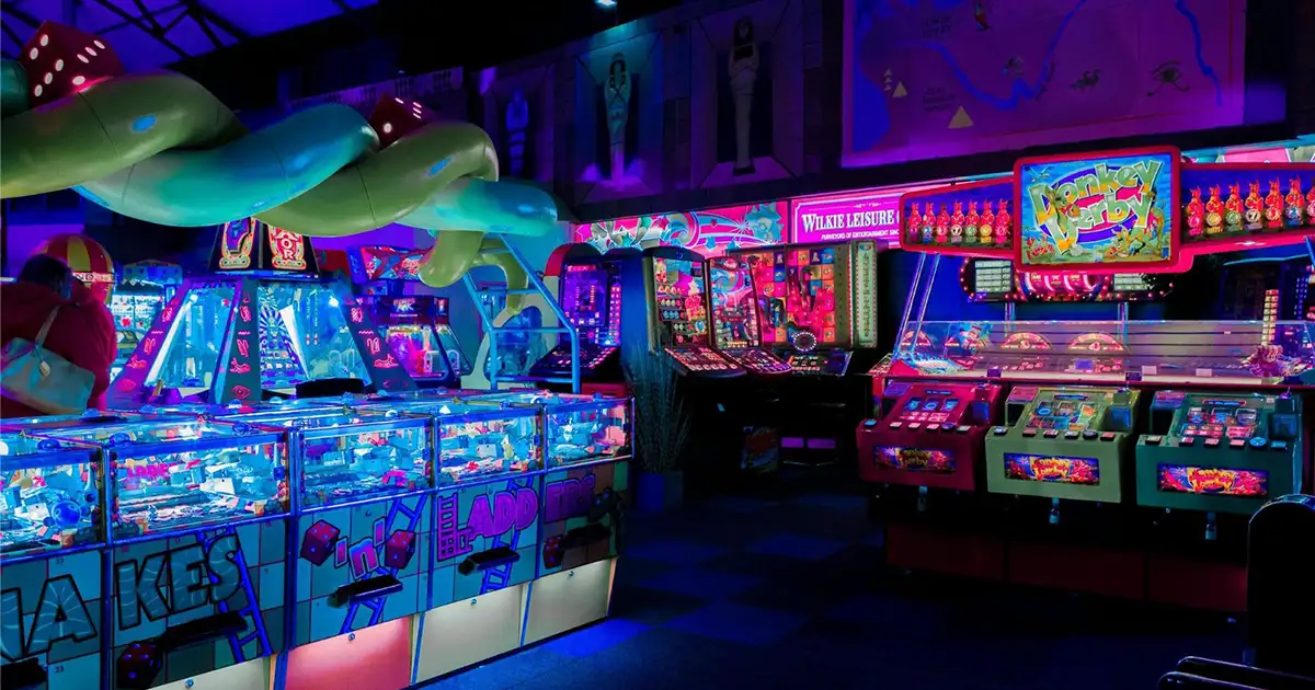 A neon-lit retro arcade with classic 90s cabinets and nostalgic atmosphere