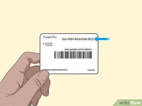 Person entering gift card details on a laptop for activation
