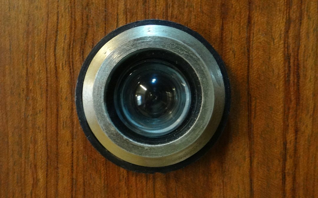 Digital peephole camera installed in an apartment door hallway