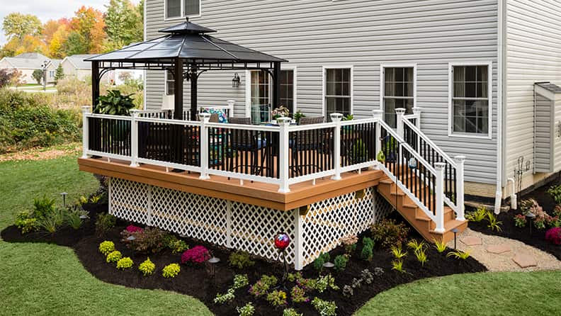 A modern multi-level deck design featuring integrated seating and lighting
