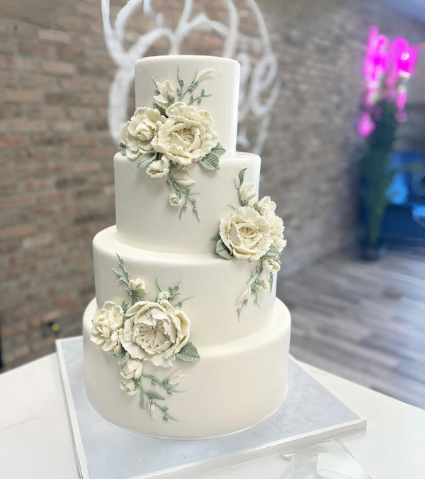 Buttercream wedding cake with sculpted white flowers