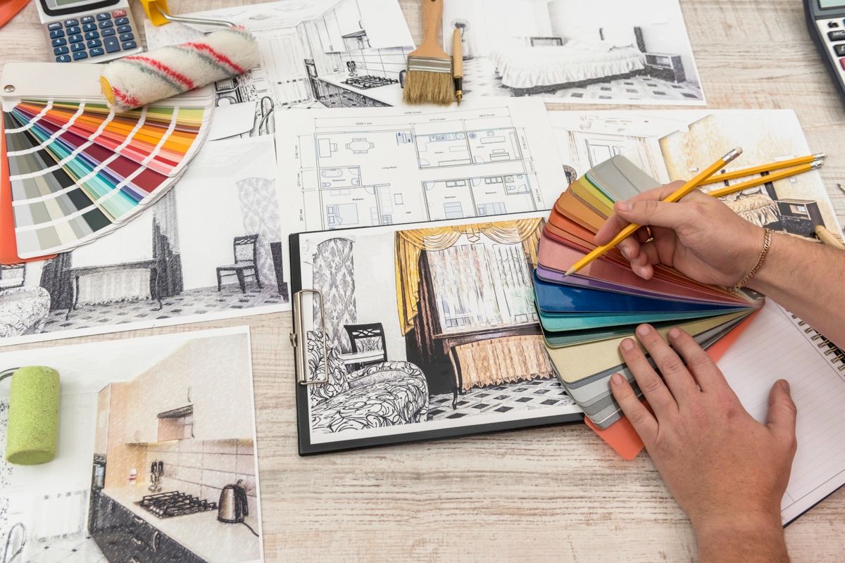 Student reviewing interior design school requirements and blueprints