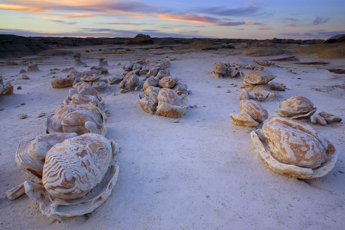 Surreal hoodoo formations in the Bisti Badlands under a clear New Mexico sky
