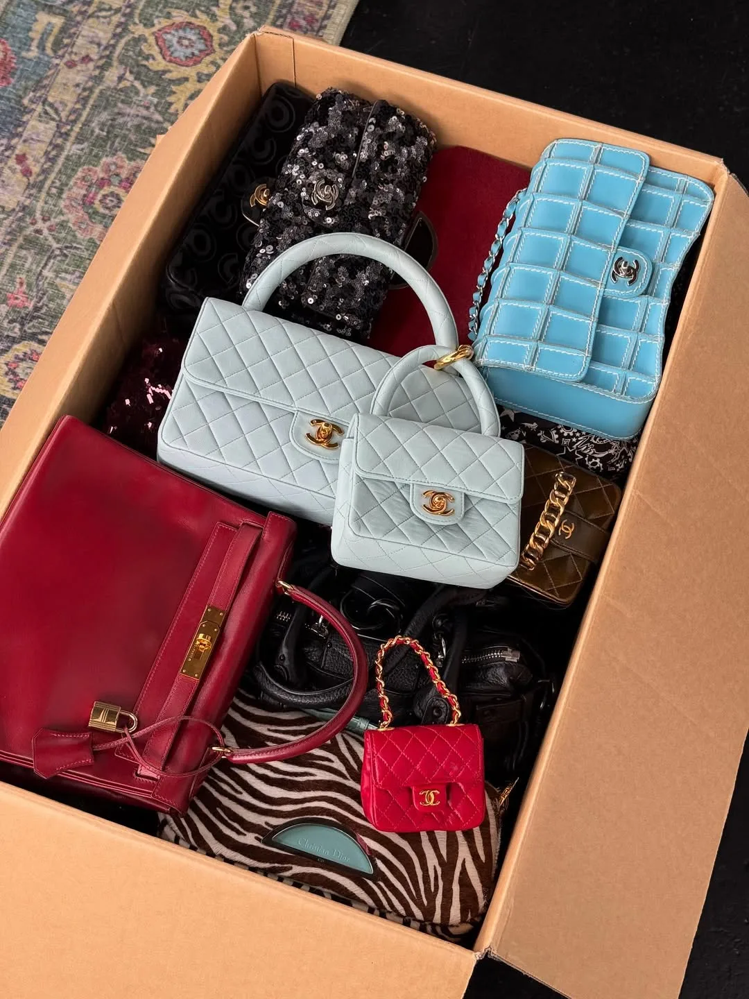 A variety of luxury bags including Chanel and Hermes