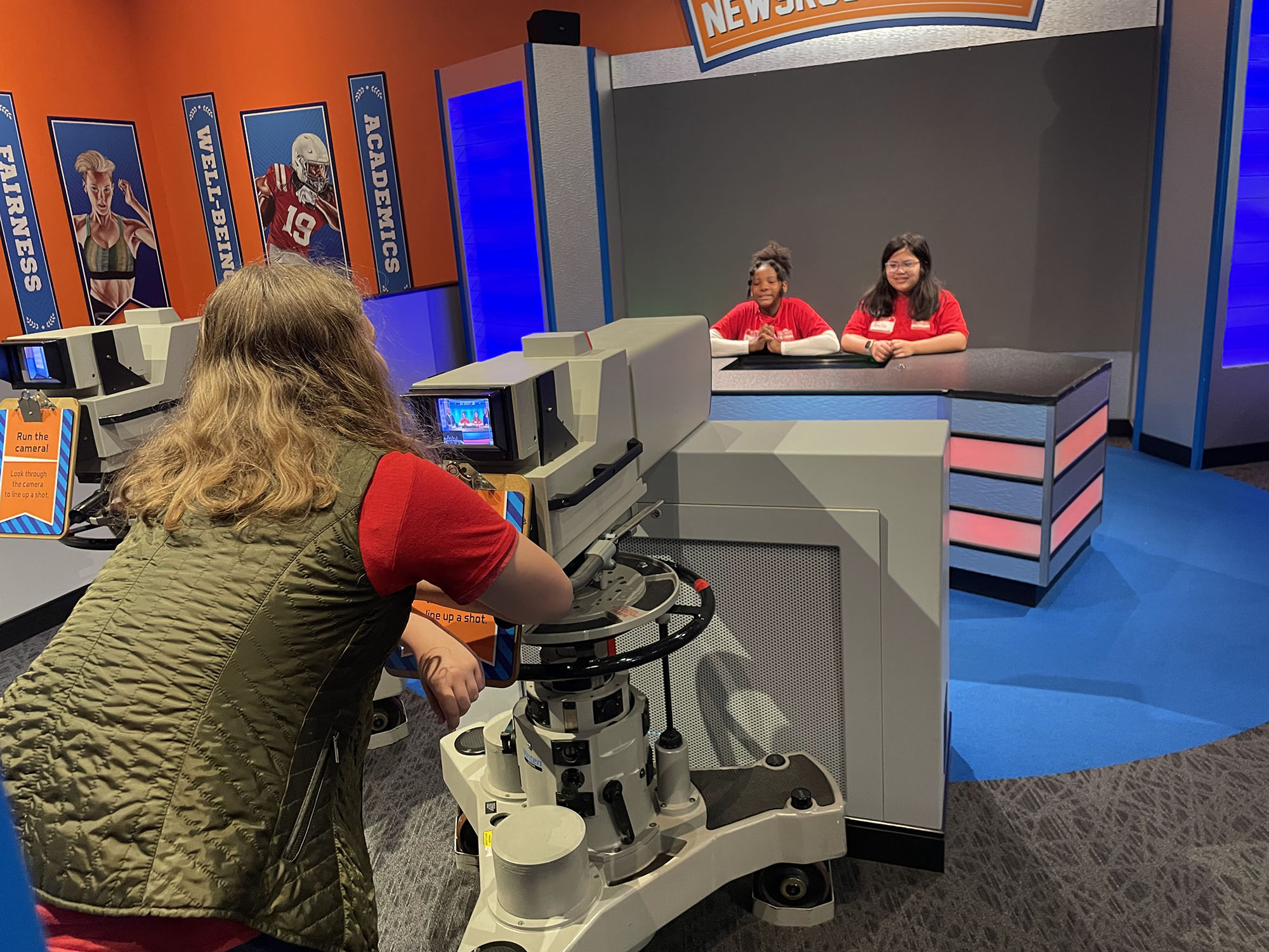 Children engaging in various physical activities to explore sports at a museum exhibit.