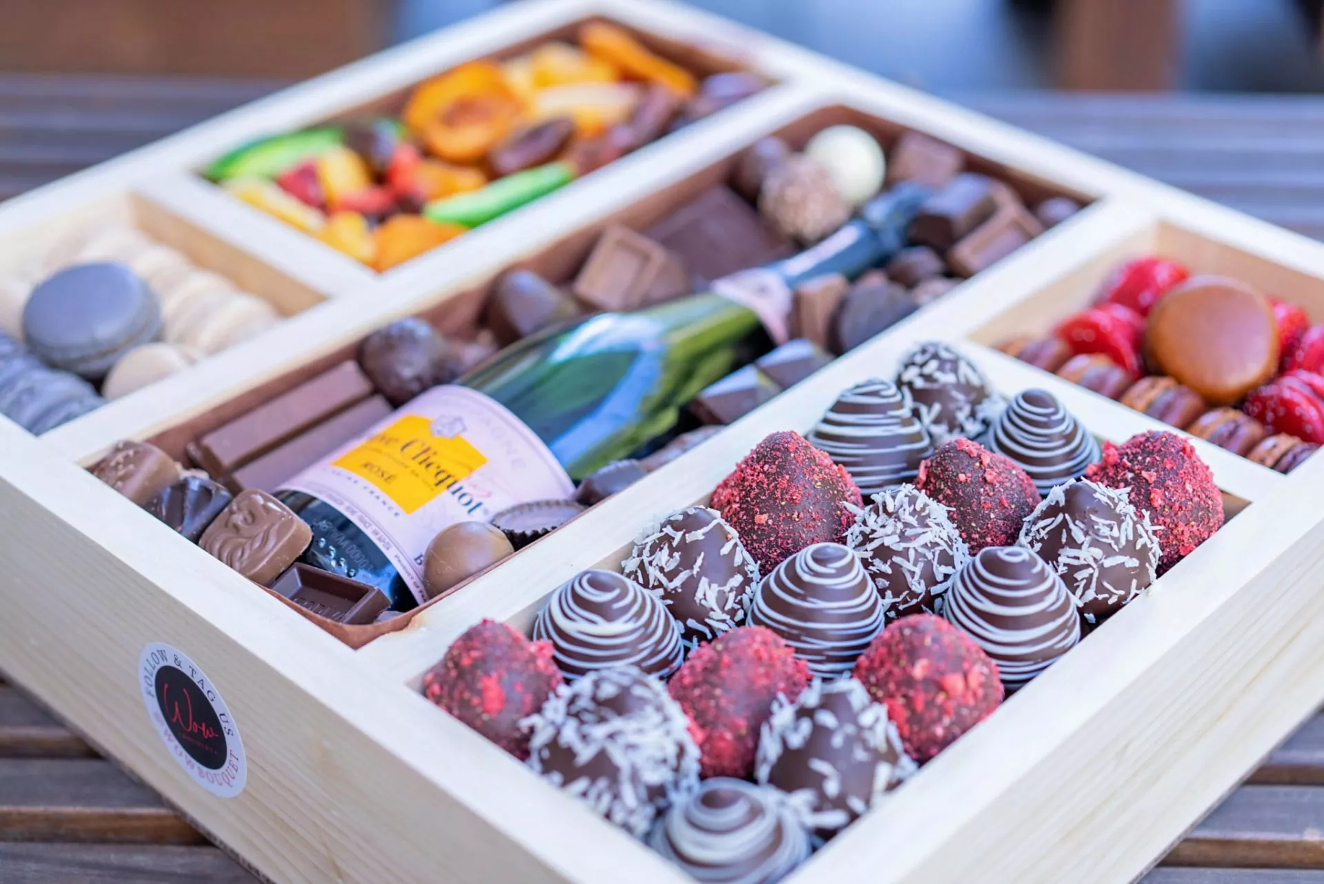 Luxury holiday gift box featuring chocolates, sweets, and macarons